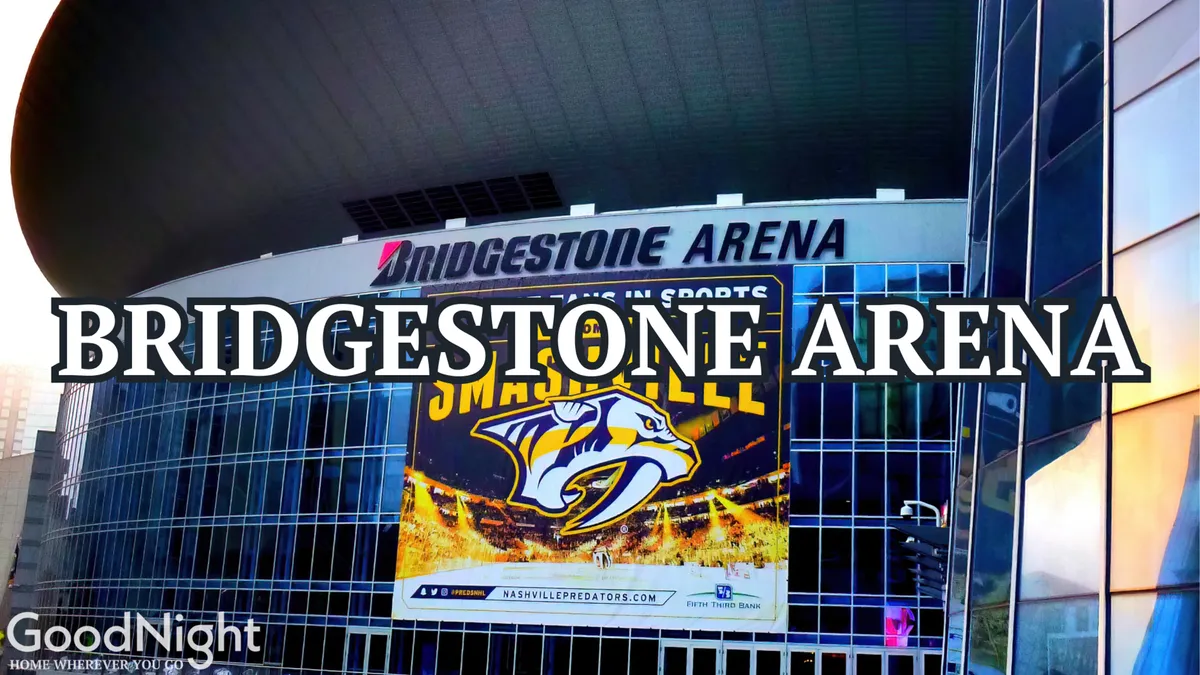 A vibrant exterior view of Bridgestone Arena, featuring the recognizable facade and Nashville Predators banner. The lively street view hints at the excitement of live events, concerts, and bustling nightlife nearby.