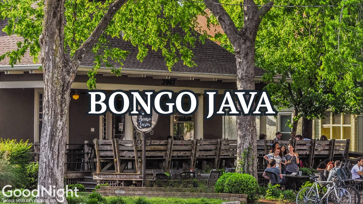An inviting outdoor seating area at Bongo Java, with people enjoying coffee under the café’s welcoming sign. The atmosphere is casual and social, reflecting Midtown’s vibrant local coffee shop culture.